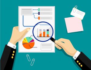 Magnifying glass, looking at graphs, report