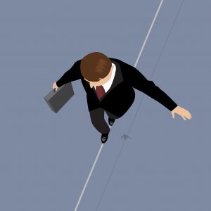 Business man in balance on a rope 